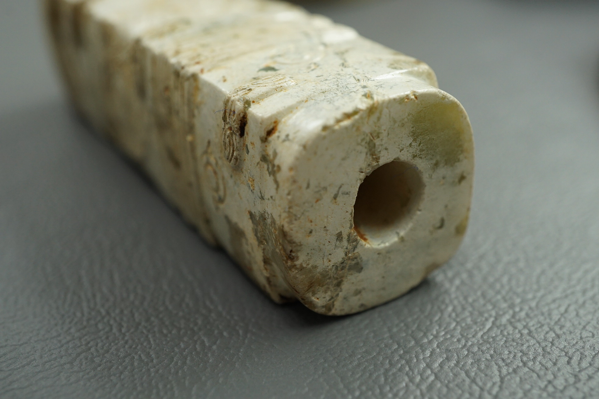 Four Chinese archaistic hardstone or burnt jade cong or cylinders